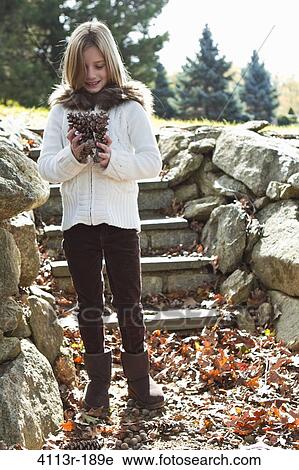Portrait of girl holding pinecones View Large Photo Image Stock Image - Portrait of girl holding pinecones. Fotosearch