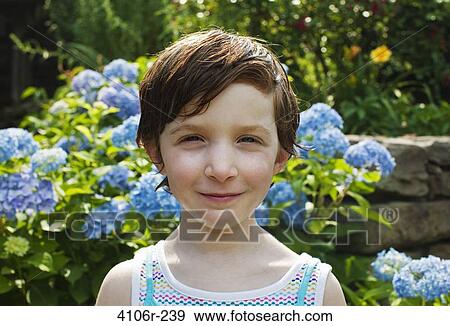 Stock Photo - Portrait of girl in garden. Fotosearch