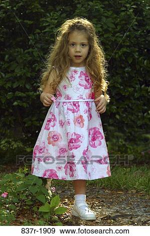 Stock Photo - Portrait of girl standing in the woods. Fotosearch