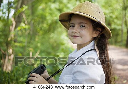 Portrait of girl wearing safari hat, holding binoculars View Large Photo Image Stock Image - Portrait of girl wearing safari hat, holding binoculars. Fotosearch