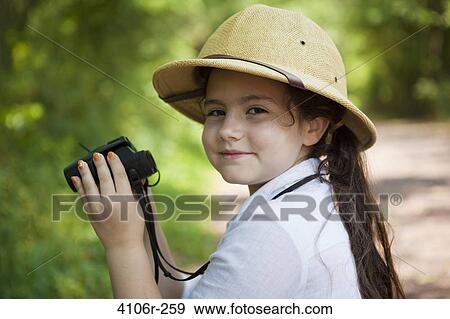 Portrait of girl wearing safari hat, holding binoculars View Large Photo Image Stock Photo - Portrait of girl wearing safari hat, holding binoculars. Fotosearch