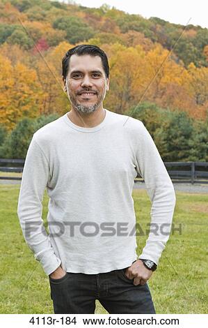 Portrait of man standing on field View Large Photo Image Picture - Portrait of man standing on field. Fotosearch