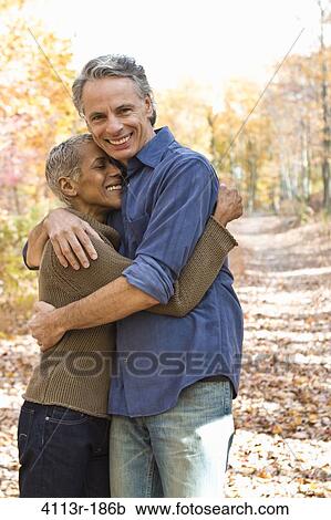 Portrait of mature couple standing on Autumn forest track View Large Photo Image Stock Image - Portrait of mature couple standing on Autumn forest track. Fotosearch