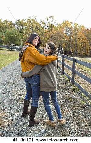 Portrait of mother and daughter on field View Large Photo Image Stock Image - Portrait of mother and daughter on field. Fotosearch