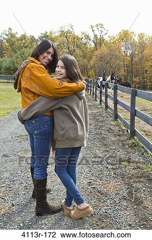 Portrait of mother and daughter on field View Large Photo Image Stock Image - Portrait of mother and daughter on field. Fotosearch