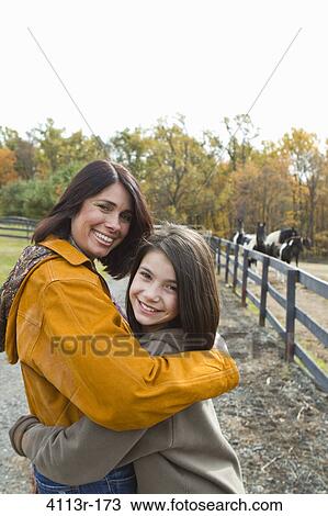 Portrait of mother and daughter on field View Large Photo Image Stock Image - Portrait of mother and daughter on field. Fotosearch