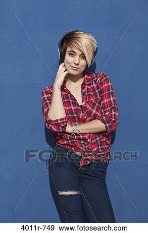 Stock Photo - Portrait of punk girl wearing headphones. Fotosearch
