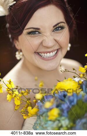 Portrait of smiling bride holding bouquet View Large Photo Image Stock Image - Portrait of smiling bride holding bouquet. Fotosearch