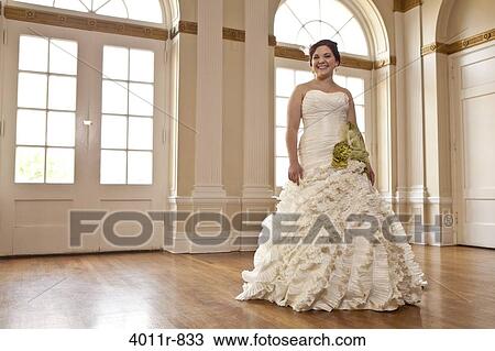 Portrait of smiling bride standing in reception hall View Large Photo Image Stock Image - Portrait of smiling bride standing in reception hall. Fotosearch