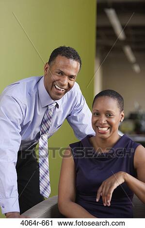 Stock Image - Portrait of smiling business couple. Fotosearch