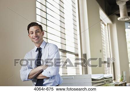 Portrait of smiling businessman in office View Large Photo Image Stock Photography - Portrait of smiling businessman in office. Fotosearch