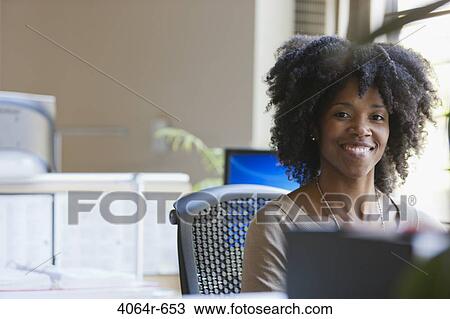 Portrait of smiling businesswoman at desk View Large Photo Image Stock Image - Portrait of smiling businesswoman at desk. Fotosearch