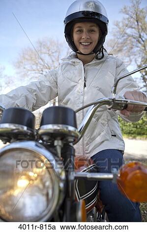 Portrait of smiling teenage girl sitting on motorcycle View Large Photo Image Stock Image - Portrait of smiling teenage girl sitting on motorcycle. Fotosearch