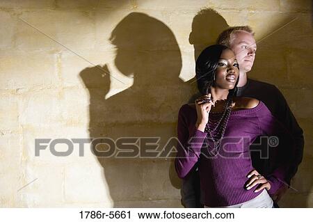 Stock Image - Portrait of stylish young interracial couple. Fotosearch