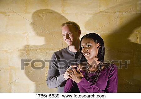 Stock Photo - Portrait of stylish young interracial couple. Fotosearch
