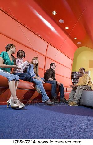 Portrait of teenage boys and girls hanging out in the library View Large Photo Image Picture - Portrait of teenage boys and girls hanging out in the library. Fotosearch