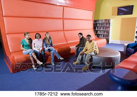Portrait of teenage boys and girls hanging out in the library View Large Photo Image Stock Image - Portrait of teenage boys and girls hanging out in the library. Fotosearch