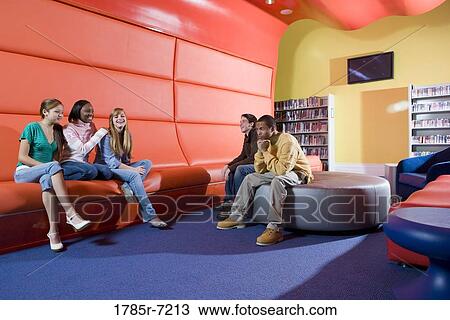 Portrait of teenage boys and girls hanging out in the library View Large Photo Image Stock Image - Portrait of teenage boys and girls hanging out in the library. Fotosearch