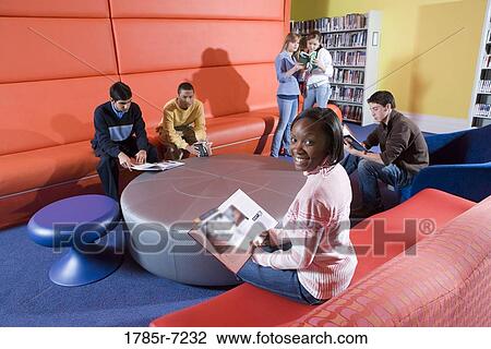 Portrait of teenage boys and girls sitting in the library, reading and socializing View Large Photo Image Stock Image - Portrait of teenage boys and girls sitting in the library, reading and socializing. Fotosearch