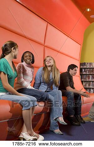 Portrait of teenage boys and girls hanging out in the library View Large Photo Image Stock Photograph - Portrait of teenage boys and girls hanging out in the library. Fotosearch