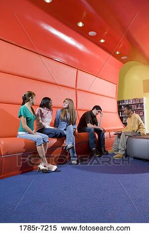 Portrait of teenage boys and girls hanging out in the library View Large Photo Image Stock Photography - Portrait of teenage boys and girls hanging out in the library. Fotosearch