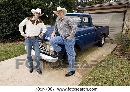 Portrait of Tex-Mex father and son by a pick-up truck in front of house View Large Photo Image Stock Photo - Portrait of Tex-Mex father and son by a pick-up truck in front of house. Fotosearch