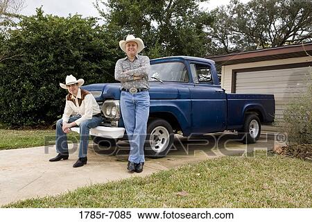 Portrait of Tex-Mex father and son by a pick-up truck in front of house View Large Photo Image Stock Photography - Portrait of Tex-Mex father and son by a pick-up truck in front of house. Fotosearch