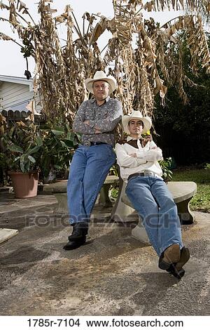 Portrait of Tex-Mex father and son in the backyard of their house View Large Photo Image Picture - Portrait of Tex-Mex father and son in the backyard of their house. Fotosearch