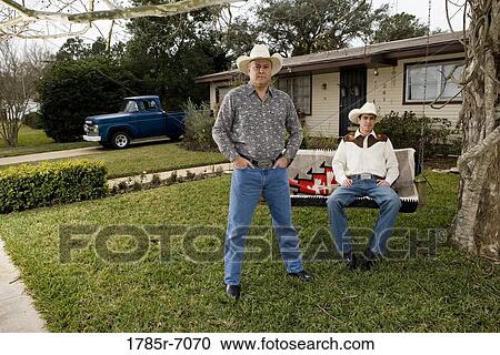 Portrait of Tex-Mex father and son in in front yard of house View Large Photo Image Stock Image - Portrait of Tex-Mex father and son in in front yard of house. Fotosearch