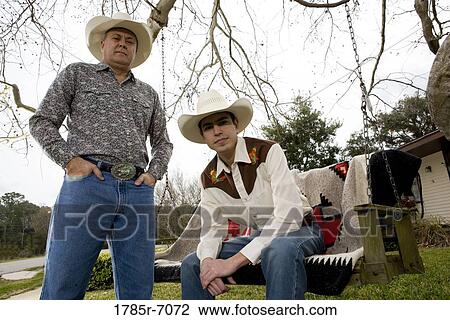 Portrait of Tex-Mex father and son in in front yard of house View Large Photo Image Stock Image - Portrait of Tex-Mex father and son in in front yard of house. Fotosearch