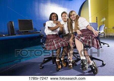Portrait of three teenage girl students wearing uniforms in a classroom View Large Photo Image Stock Photo - Portrait of three teenage girl students wearing uniforms in a classroom. Fotosearch