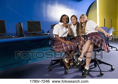 Portrait of three teenage girl students wearing uniforms in a classroom View Large Photo Image Stock Photograph - Portrait of three teenage girl students wearing uniforms in a classroom. Fotosearch