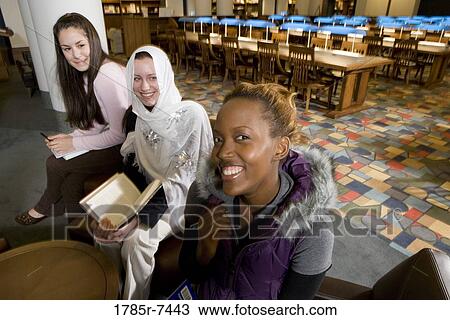 Portrait of three women students in a sitting lounge in a library View Large Photo Image Stock Image - Portrait of three women students in a sitting lounge in a library. Fotosearch