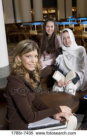 Portrait of three women students in a sitting lounge in a library View Large Photo Image Stock Photography - Portrait of three women students in a sitting lounge in a library. Fotosearch