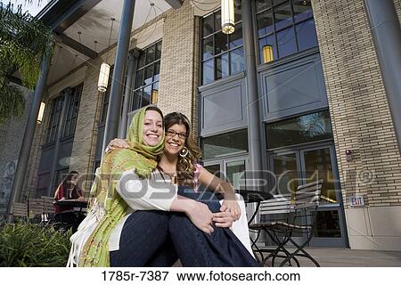 Portrait of two young women sitting together View Large Photo Image Stock Photo - Portrait of two young women sitting together. Fotosearch