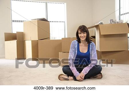 Portrait of woman as she is moving into her new home View Large Photo Image Stock Photo - Portrait of woman as she is moving into her new home. Fotosearch