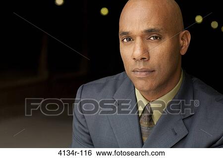 Portrait of young businessman outdoors at night View Large Photo Image Stock Photograph - Portrait of young businessman outdoors at night. Fotosearch