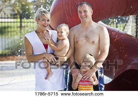 Portrait of young family by water slide View Large Photo Image Stock Photography - Portrait of young family by water slide. Fotosearch