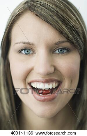 Portrait of young woman biting capsule pill View Large Photo Image Stock Photograph - Portrait of young woman biting capsule pill. Fotosearch