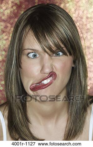 Portrait of young woman making a face View Large Photo Image Stock Photo - Portrait of young woman making a face. Fotosearch