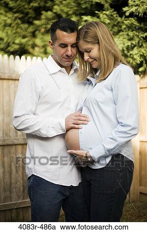 Pregnant women with her husband in the backyard View Large Photo Image Stock Image - Pregnant women with her husband in the backyard. Fotosearch