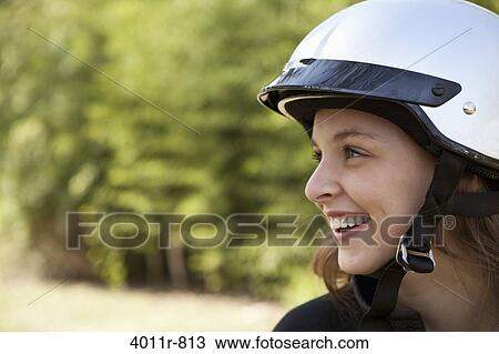 Profile of teenage girl wearing helmet and smiling View Large Photo Image Stock Image - Profile of teenage girl wearing helmet and smiling. Fotosearch