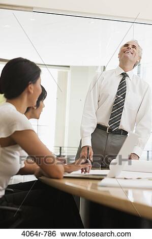 Project discussions amongst employees in boardroom View Large Photo Image Stock Photograph - Project discussions amongst employees in boardroom. Fotosearch