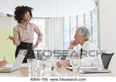 Project discussions amongst employees in boardroom View Large Photo Image Stock Photography - Project discussions amongst employees in boardroom. Fotosearch