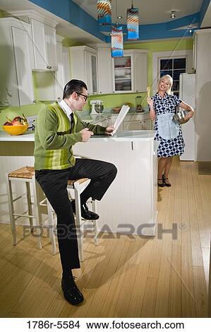 Retro couple at home in kitchen chatting View Large Photo Image Picture - Retro couple at home in kitchen chatting. Fotosearch