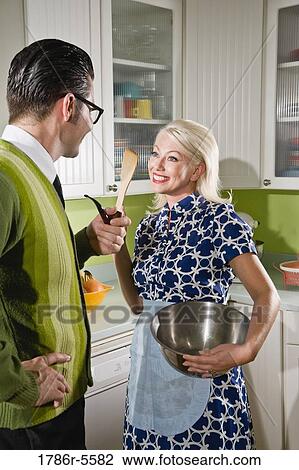 Retro couple at home in kitchen chatting View Large Photo Image Stock Image - Retro couple at home in kitchen chatting. Fotosearch