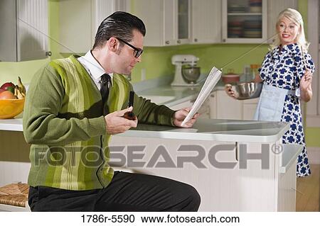 Stock Image - Retro couple at home in kitchen. Fotosearch