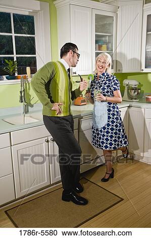 Stock Image - Retro couple enjoying domestic life. Fotosearch