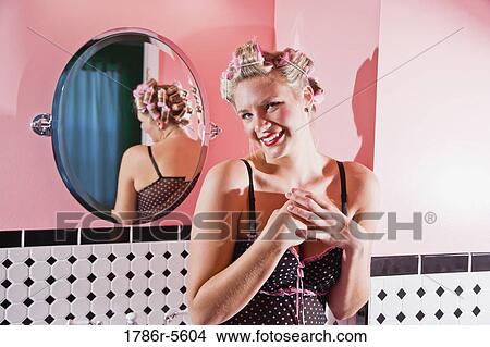 Retro pin-up girl with curlers in hair View Large Photo Image Picture - Retro pin-up girl with curlers in hair. Fotosearch