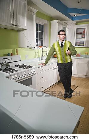 Retro style man standing home in kitchen View Large Photo Image Stock Photo - Retro style man standing home in kitchen. Fotosearch